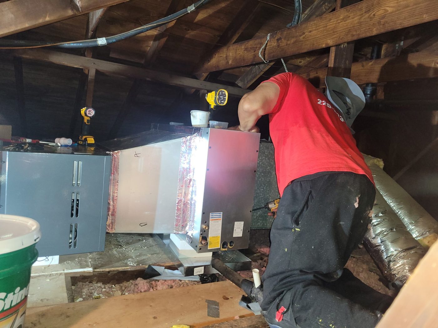 Red Stick technician installing an attic coil