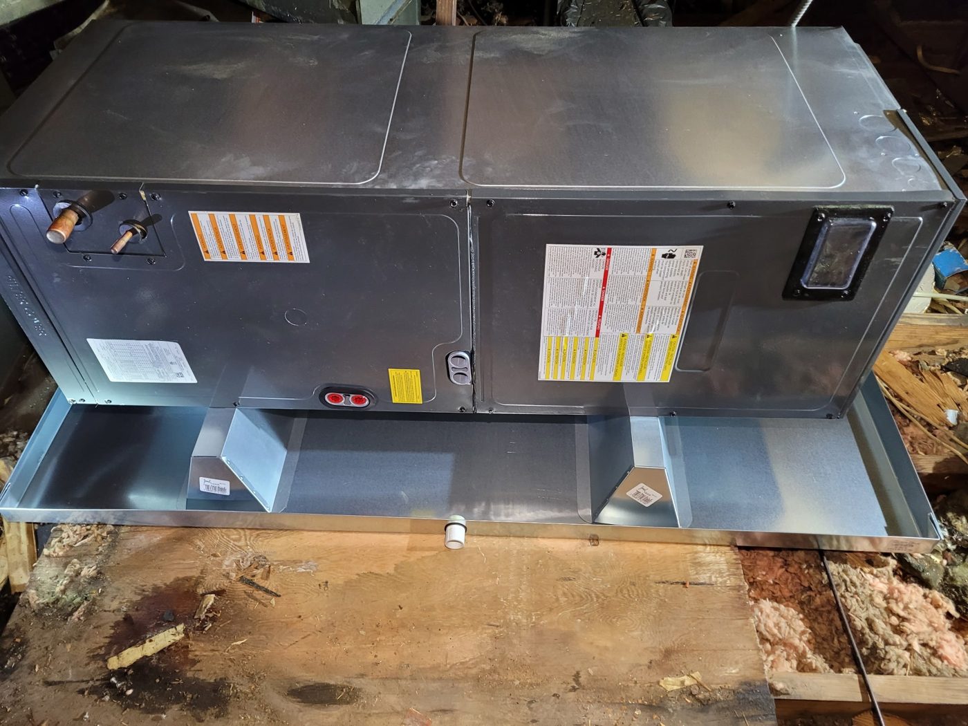 New air handler set in an attic drain pan