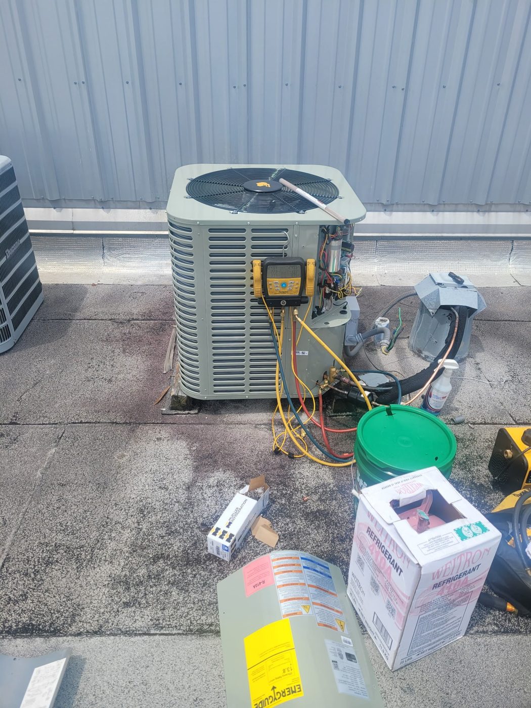 Rooftop condenser being charged with digital gauges